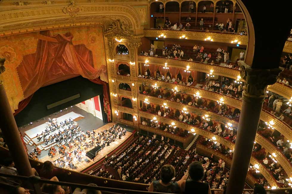 Vintage theater full with people watching a show in Buenos Aires.