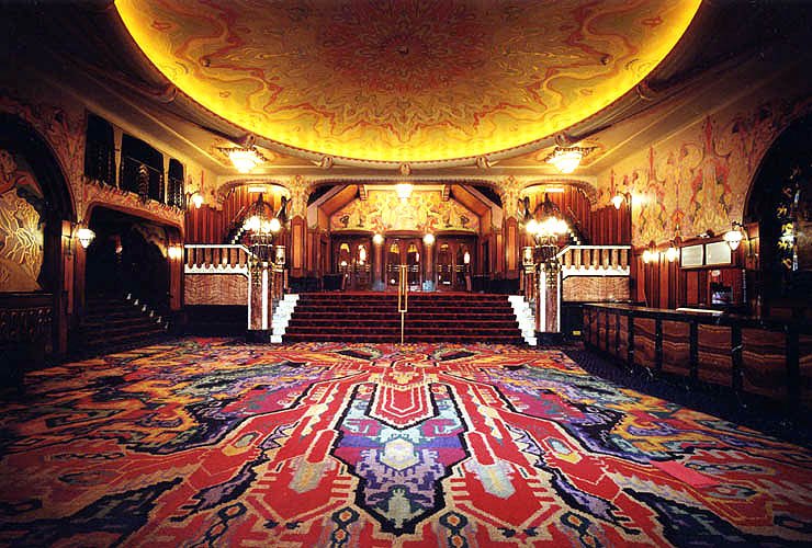 Vintage room with wooden furniture and red carpet in the Pathe Tuschinski movie theather in Amsterdam.