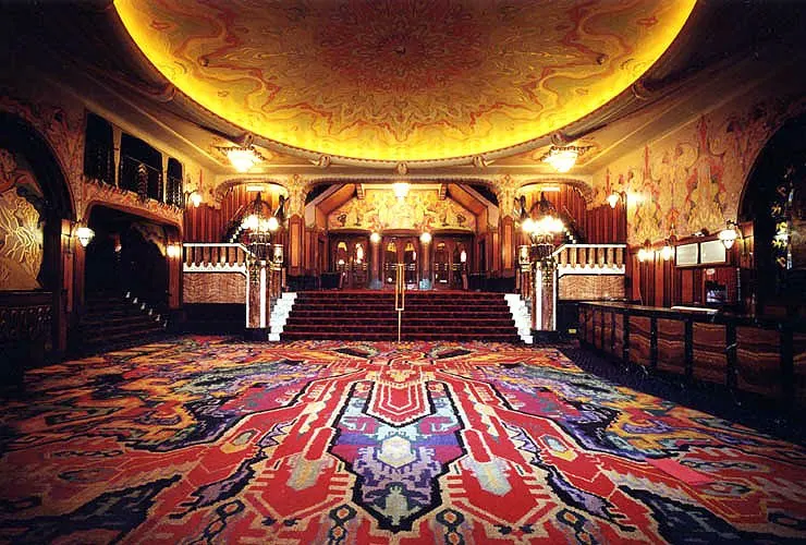 Vintage room with wooden furniture and red carpet in the Pathe Tuschinski movie theather in Amsterdam.