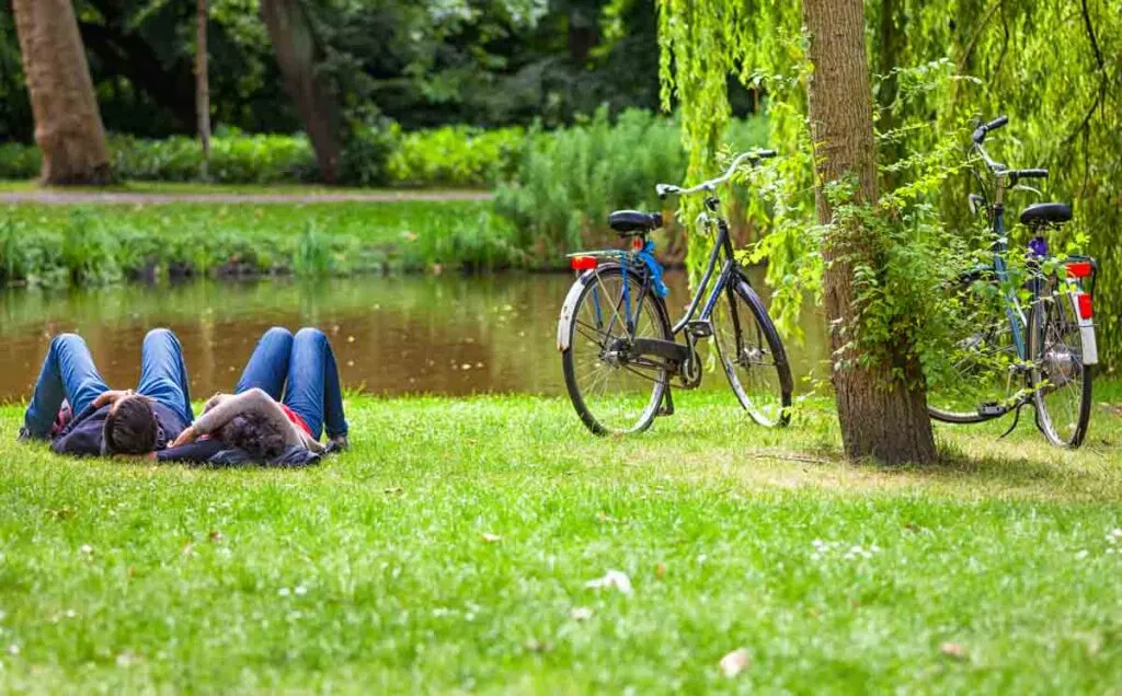 Young couple relaxing on the grass of the Vondelpark