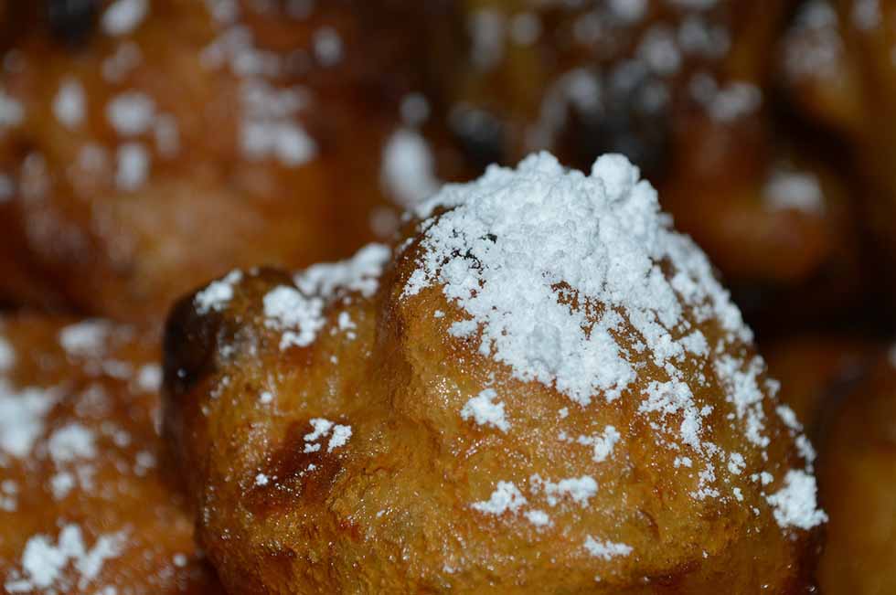 Dutch oliebollen Christmas food sprinkled with powdered sugar.