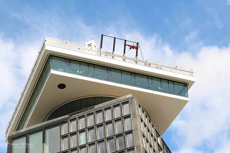 People swinging onto the A'DAM Tower building in Amsterdam, the Netherlands.
