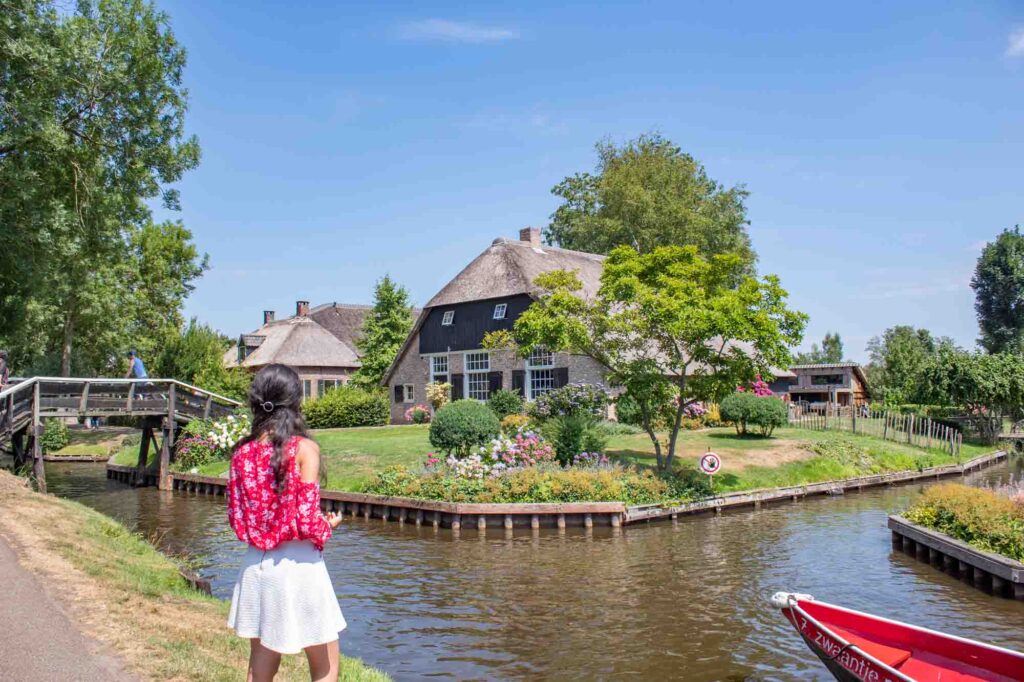 Brunette staring at a cottage in Giethoorn, the Netherlands