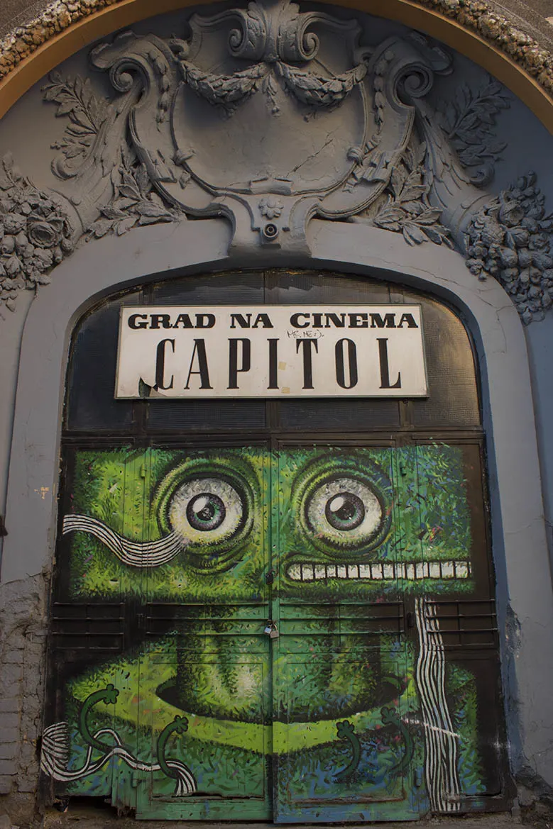 Summer Theatre Capitol in Bucharest with a green graffiti on its doors