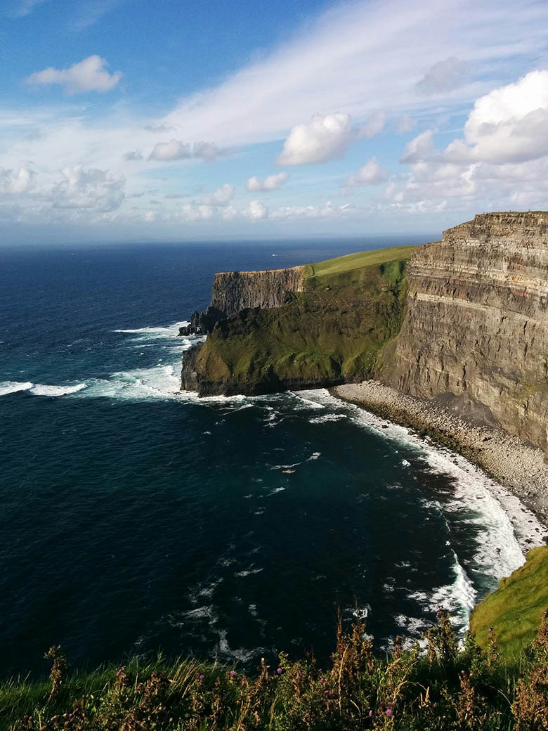 Cliffs of Moher in Claire County, Ireland, near the Atlantic Ocean in a sunny day #Ireland #CliffsofMoher #Europe #Travel