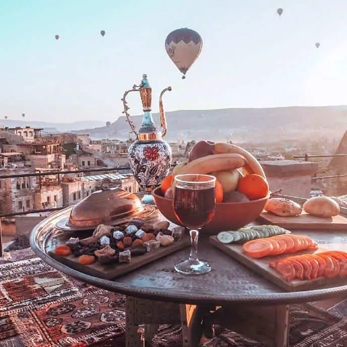 Breakfast in Cappadocia, Turkey. Hot air balloons in the background.