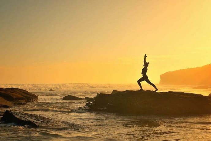 Woman exercising on the beach. Galicia, Spain.