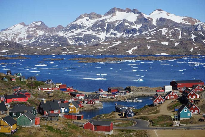 Houses and mountains covered in snow in Greenland