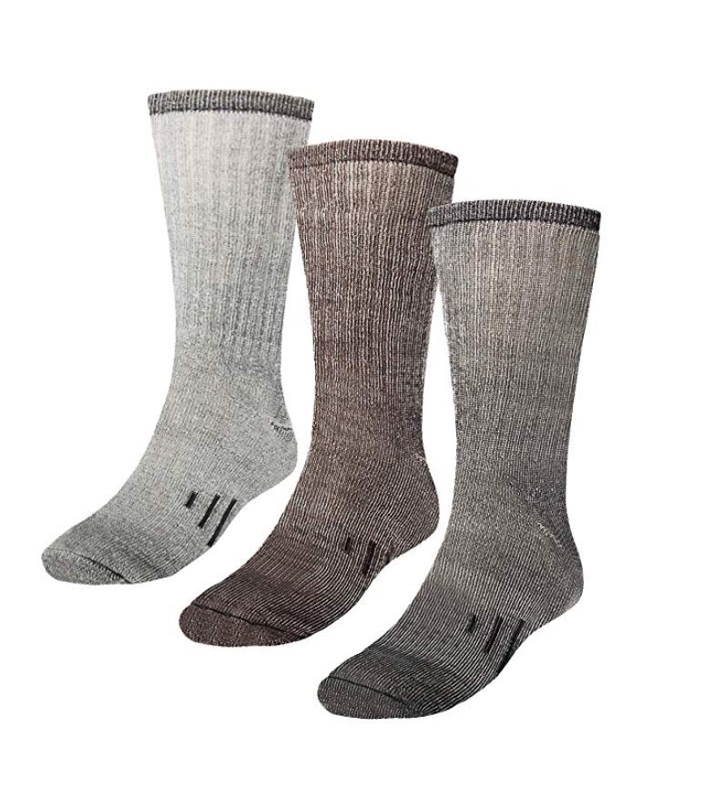 Three gray, woolen socks and a white background.