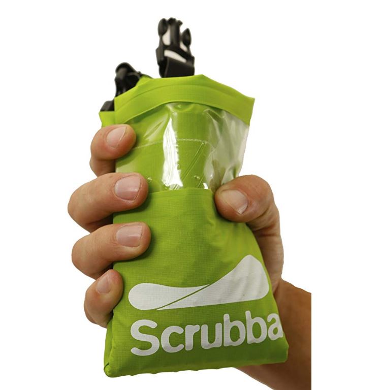 Hand holding green wash bag for travel in Europe.