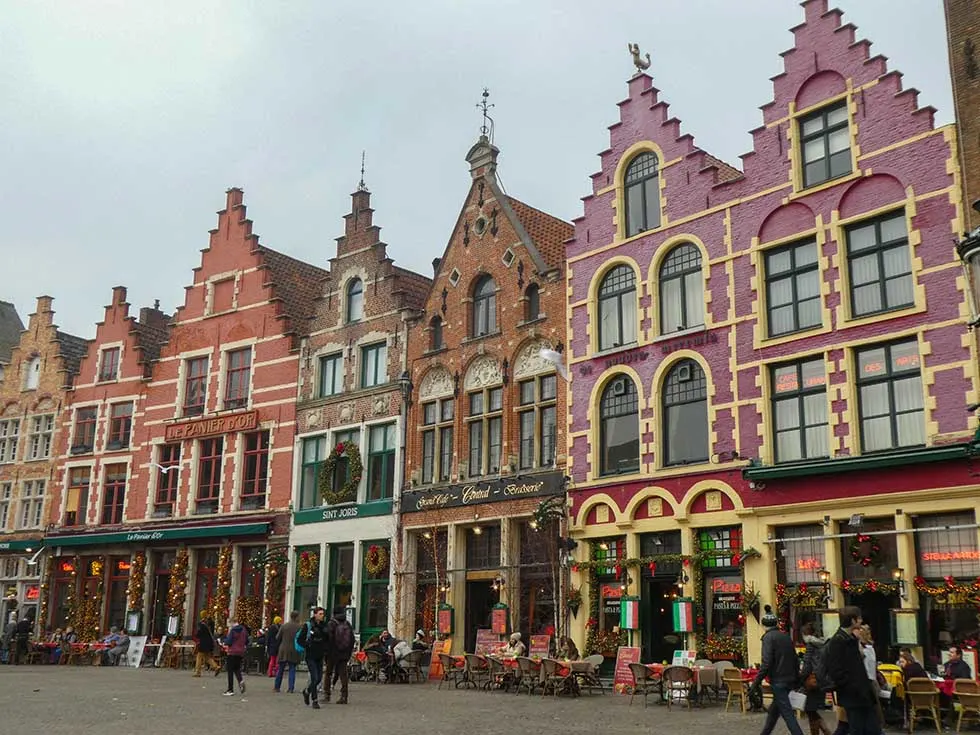 Pink and orange houses next to each other in the market in Bruges, Belgium