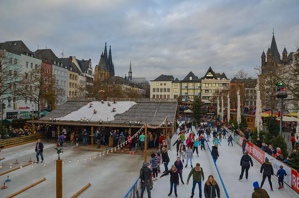 People ice skating in a Christmas market in Cologne.