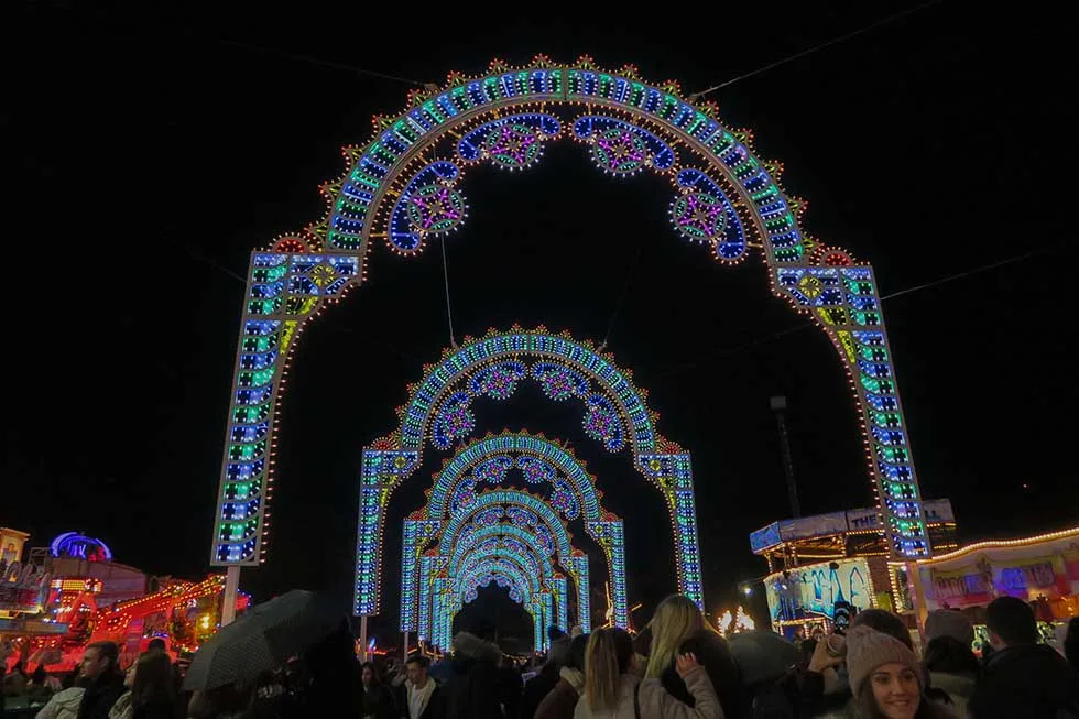 Blue lights on arches at Christmas market in London.