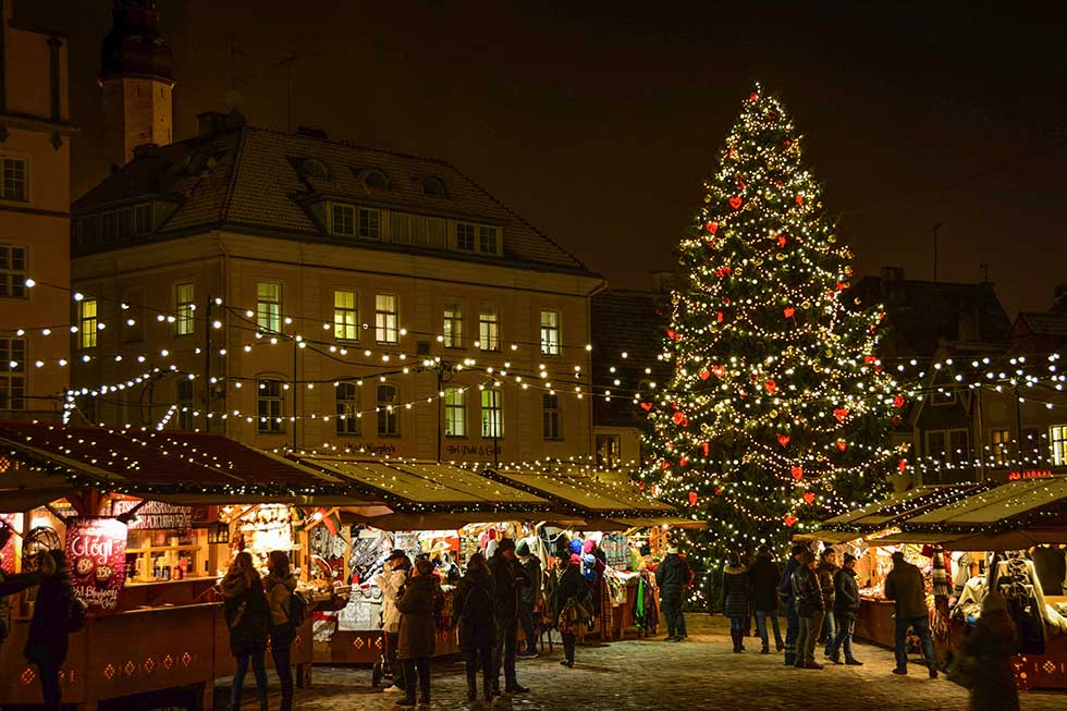 A few people walking in a Christmas market in Tallinn