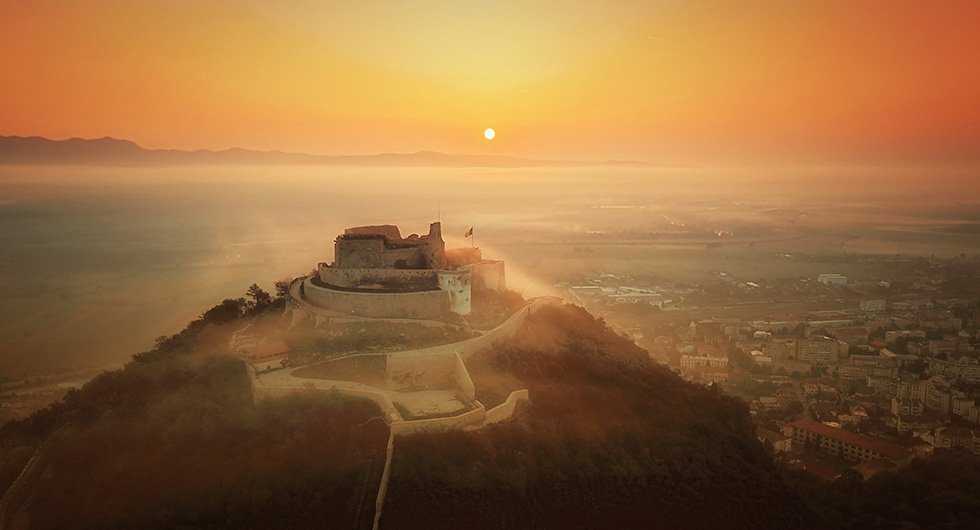 Deva Fortress on the hill watching over the city in the mist