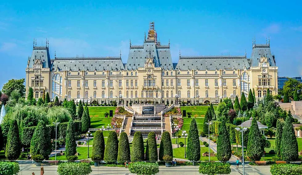 Palace of Culture in Iasi, Romania, in front of a green area in a sunny day