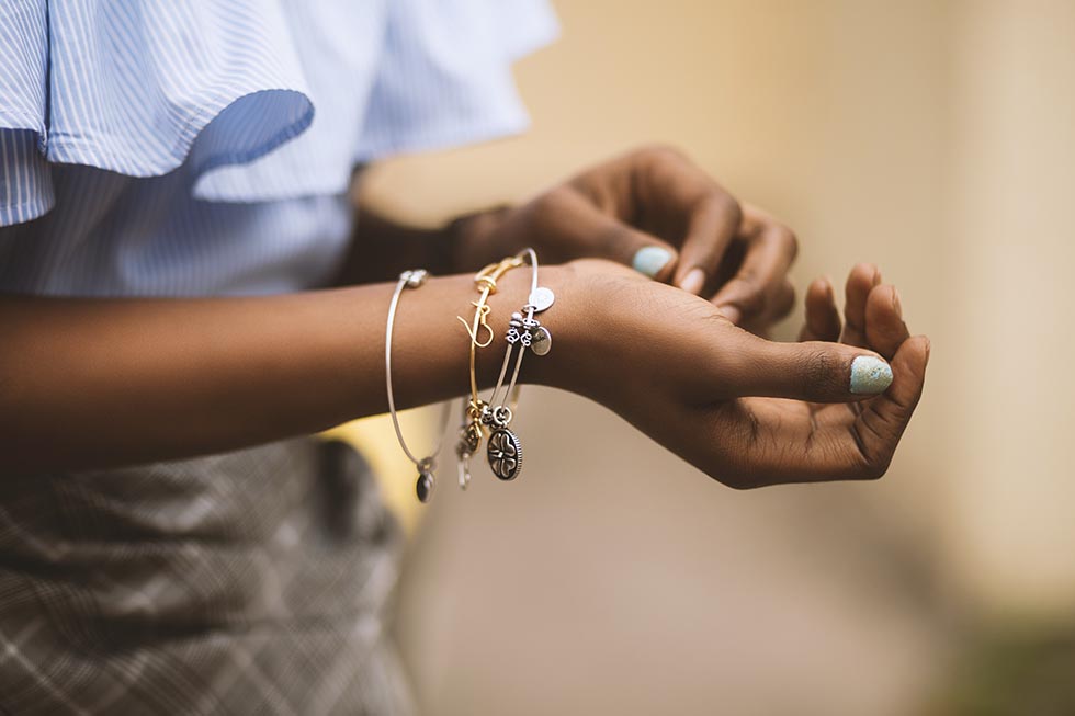 Black woman's arms wearing bracelets