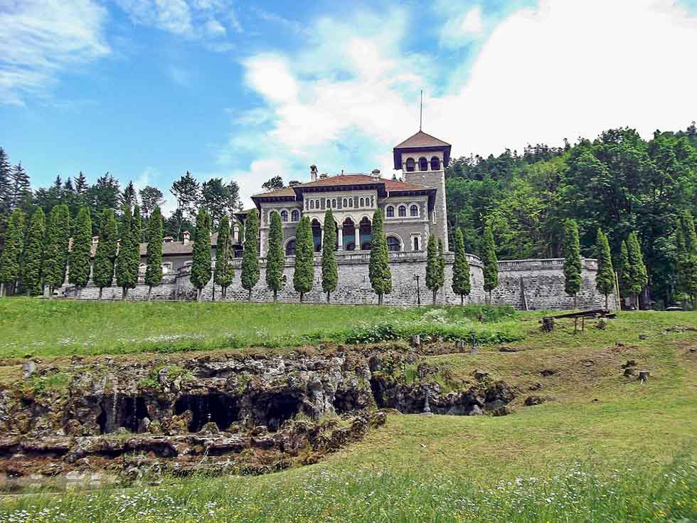 Cantacuzino Castle on a green hill in Romania