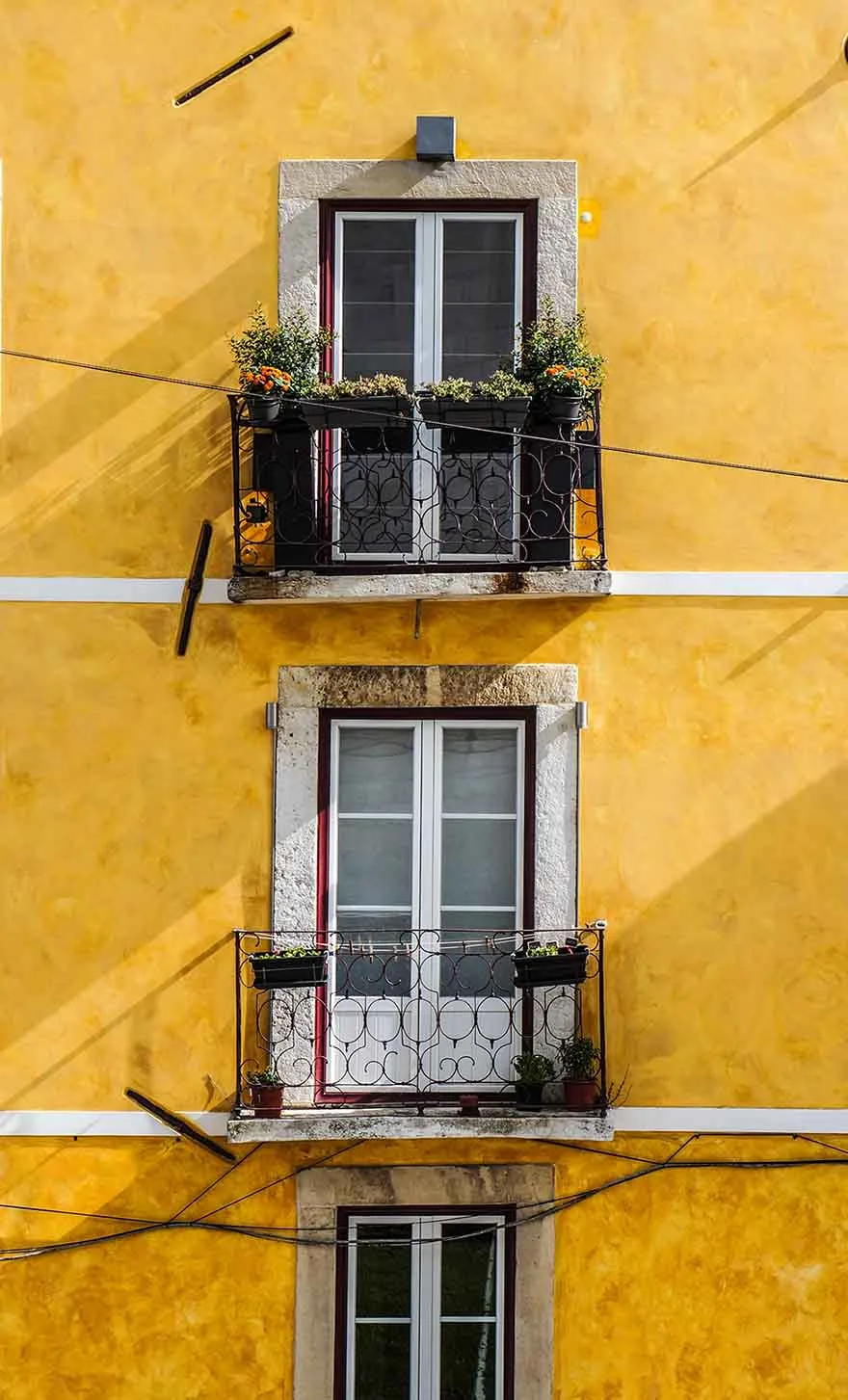 Balcony doors on a yellow building in Lisbon #Portugal #Europe #travel