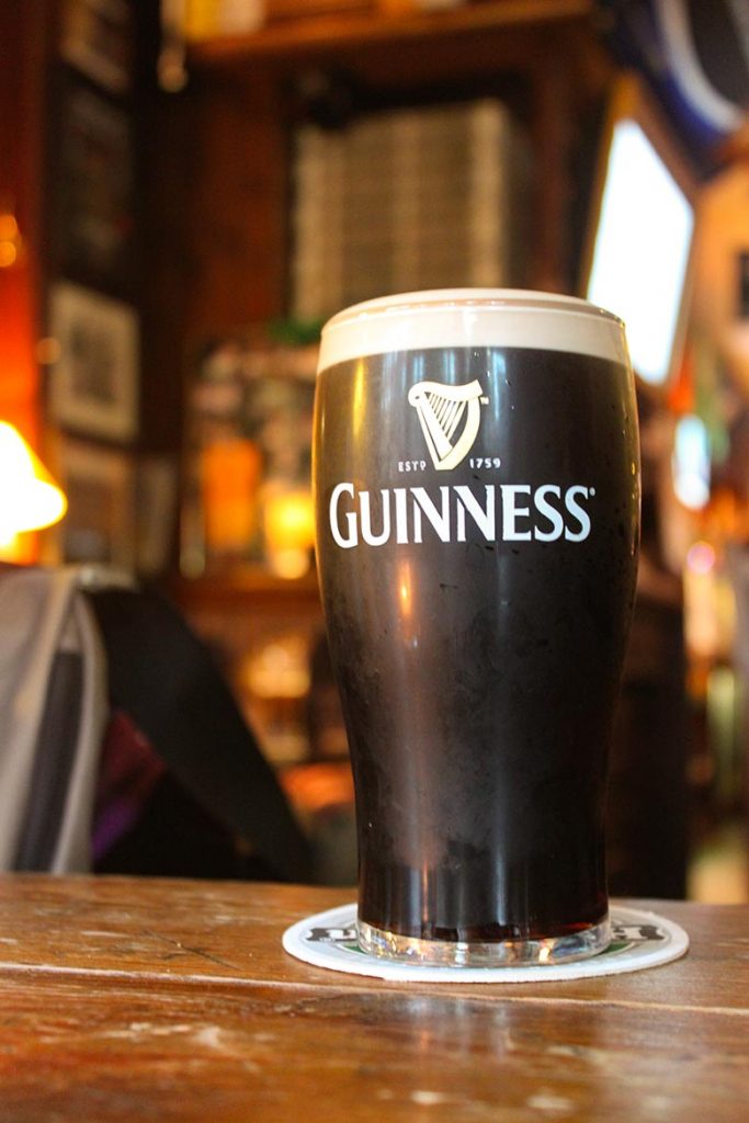 A dark beer in a glass of Guinness in a pub is the most popular Irish drink