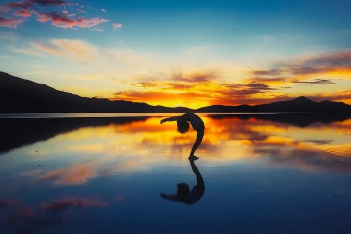 Person in the Bolivian salt flats playing with reflection