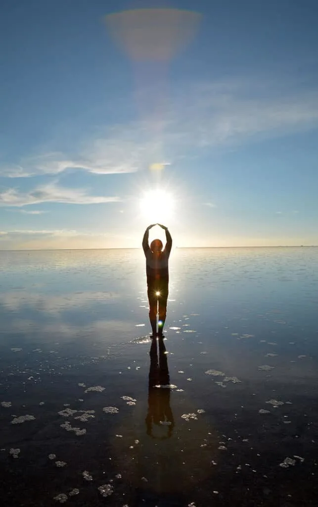 Person in the Bolivian salt flats playing with reflection