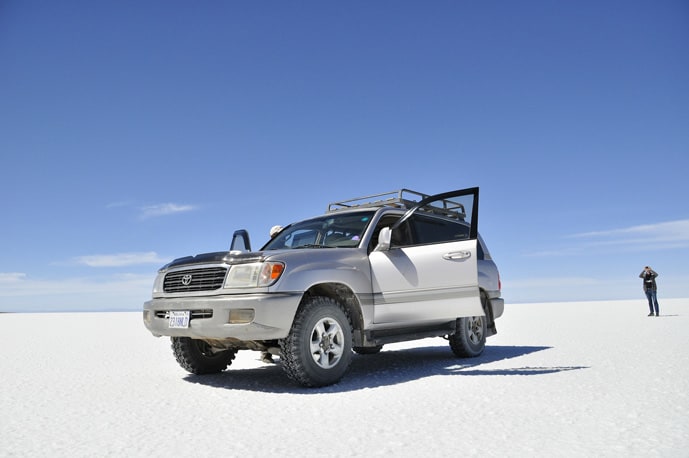 Car at salt flats in Bolivia