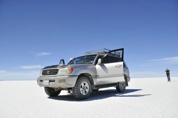 Car at salt flats in Bolivia