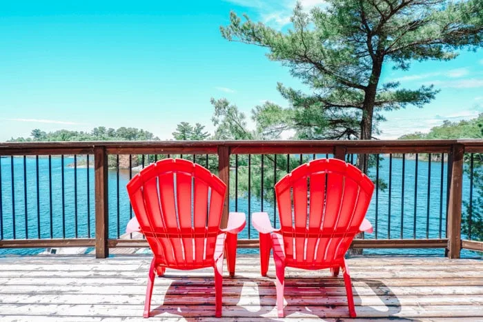 Red chairs in Muskoka, a great Canada road trip