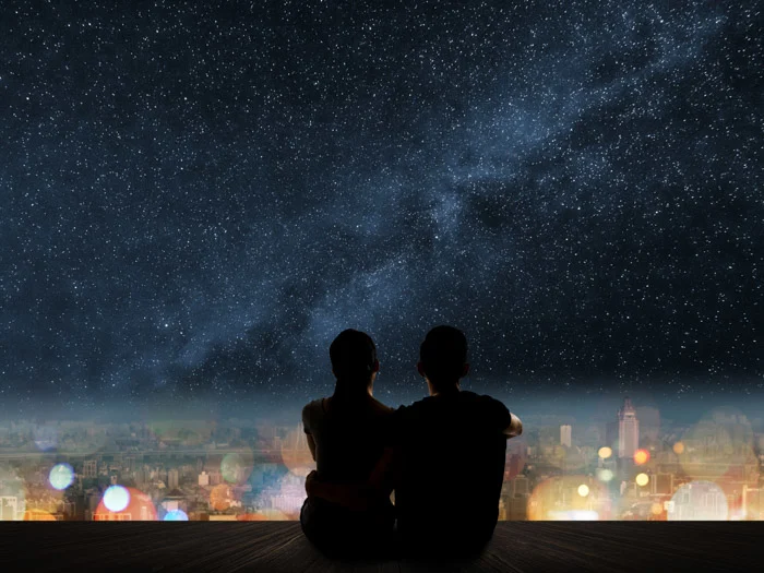 Couple sitting under the stars