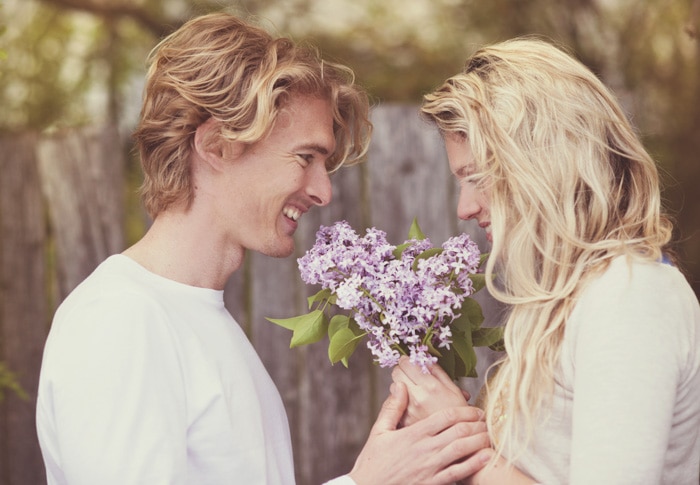 Romantic couple holding flowers