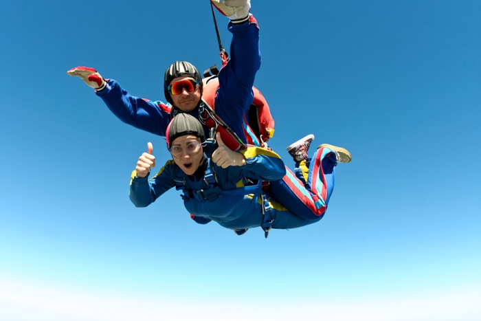 Couple sky diving together