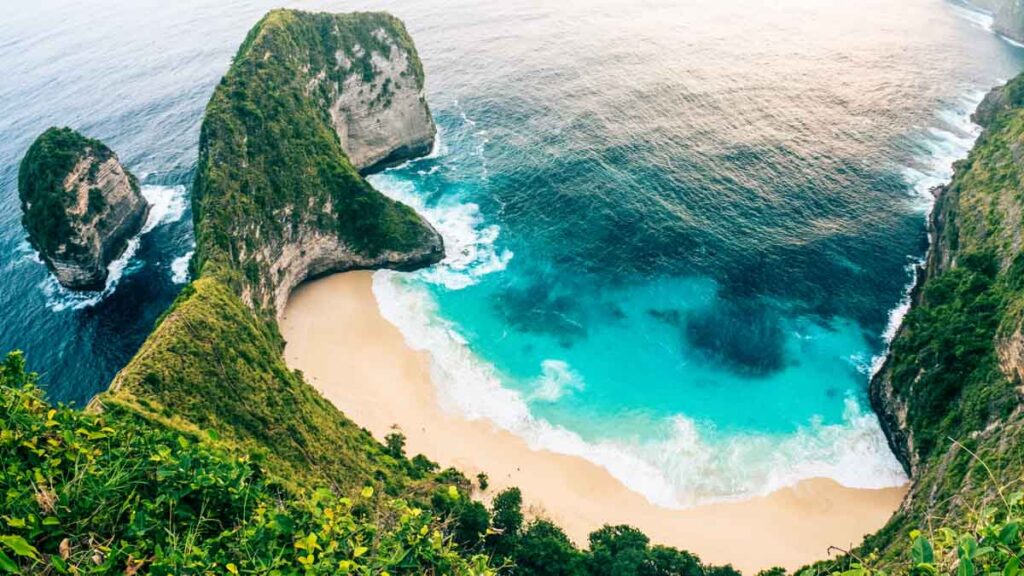 Picturesque cliffs, gold beach and crystal blue waters of Bali, Indonesia