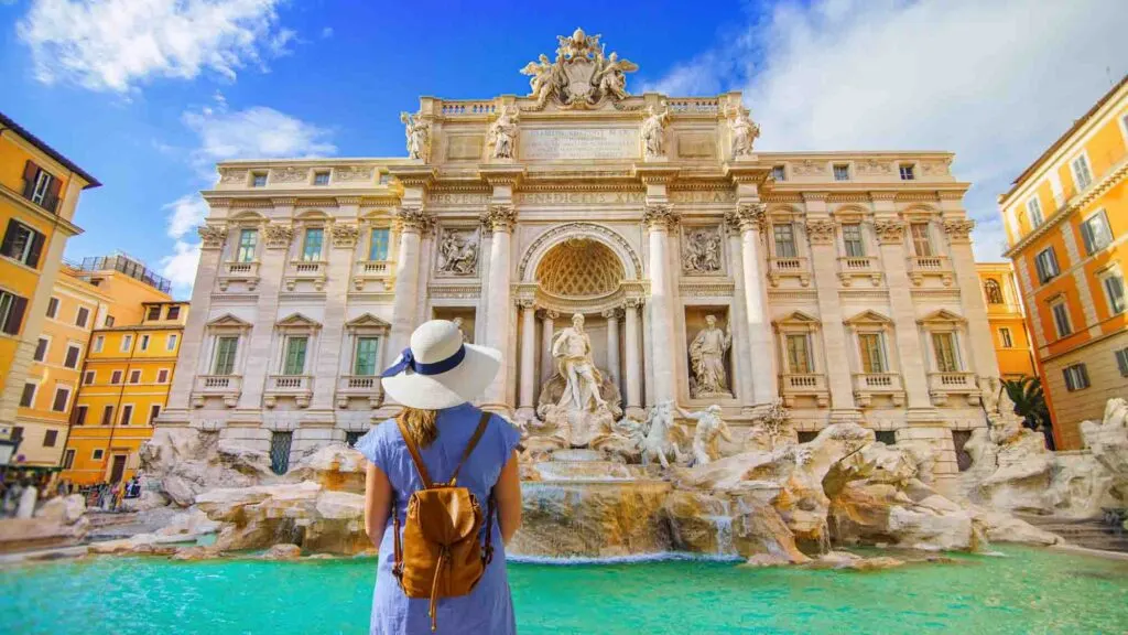 Woman facing Fountain di Trevi in Rome, Italy