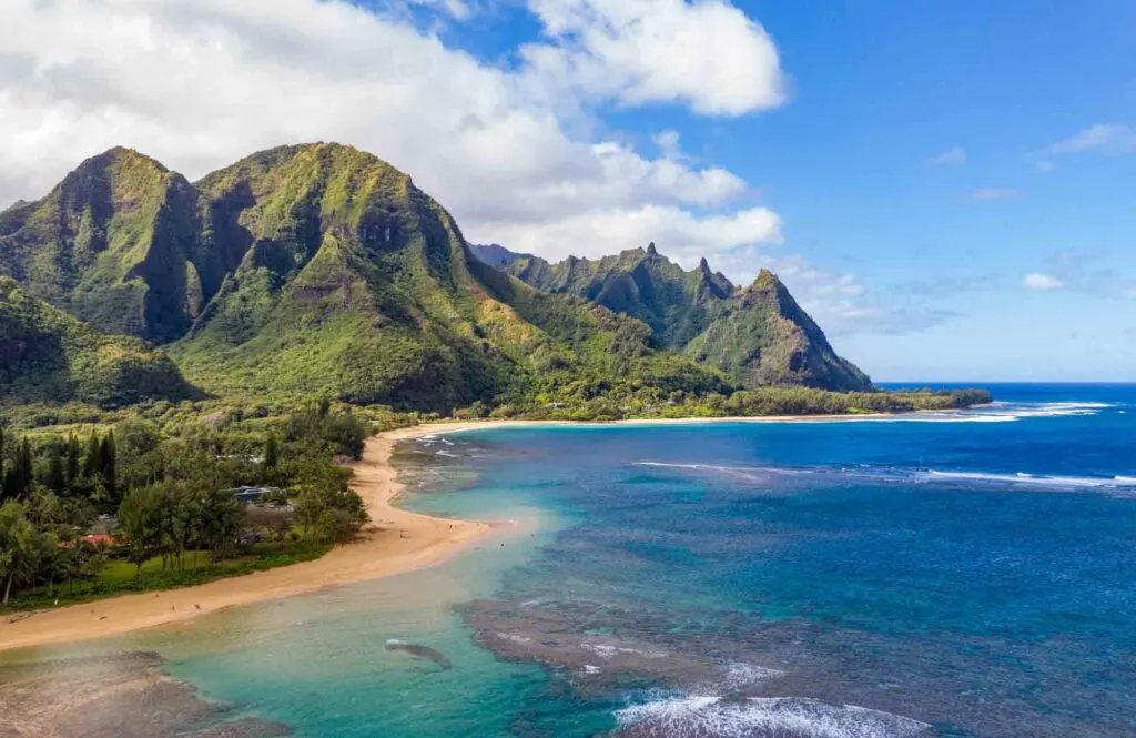 Aerial photo off the coast over Tunnels beach on Hawaiian island of Kauai with Na Pali mountains behind, Hawaii